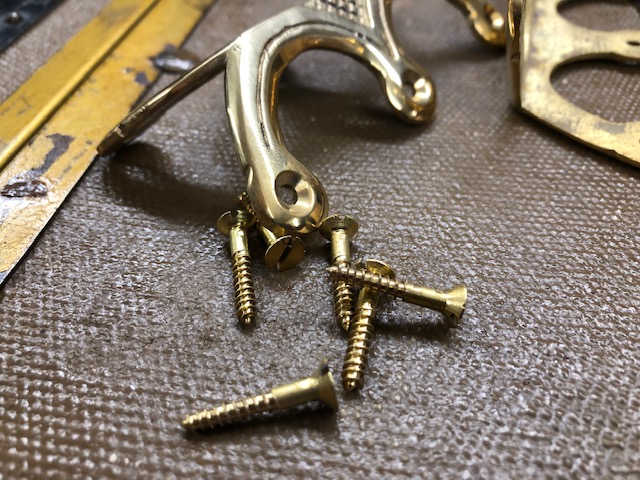Close up picture of brass trunk hardware