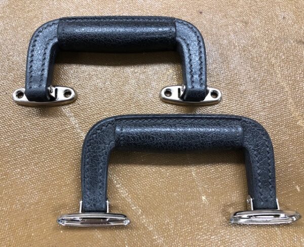 Molded suitcase handle with attached mounting brackets